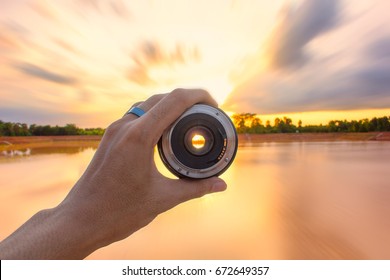 Hold The Lens To View The Landscape. See The Beautiful Golden Sky. Inside The Lens Is Light Through The Lens.