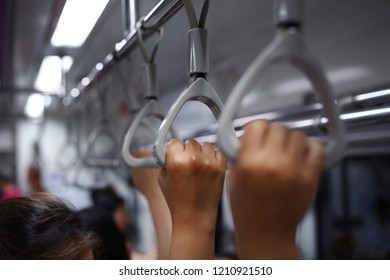 Hold on to the subway handle. - Shutterstock ID 1210921510
