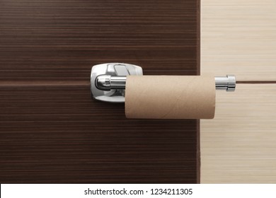 Holder With Empty Toilet Paper Roll In Bathroom