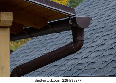 Holder gutter drainage system on the roof. Drain on the roof of the house. Roof drainage. Water drainage from the roof.