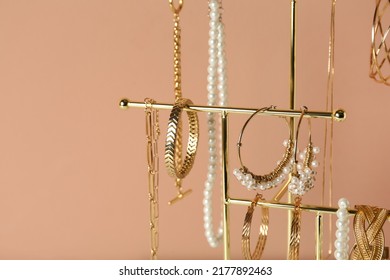 Holder and set luxurious jewelry pale pink background  closeup  Space for text