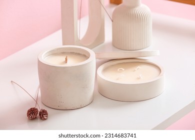 Holders with candles and decor on table in room, closeup - Powered by Shutterstock