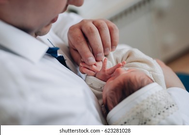holding baby's tiny hand