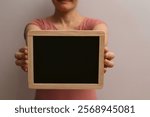 Holding Blank Blackboard. female hands holding blackboard chalkboard. Cropped image of woman holding empty black board