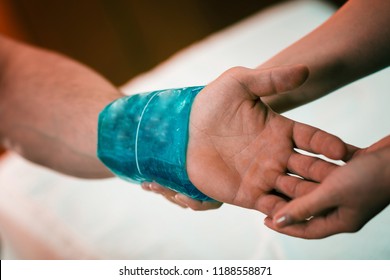 Holding The Blue Ice Pack On The Painful Wrist