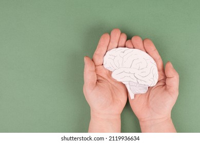 Holding a brain in the hands, Parkinson disease, Alzheimer awardness, mental disorder dementia, psychology problems, cerebral vein thrombosis - Shutterstock ID 2119936634