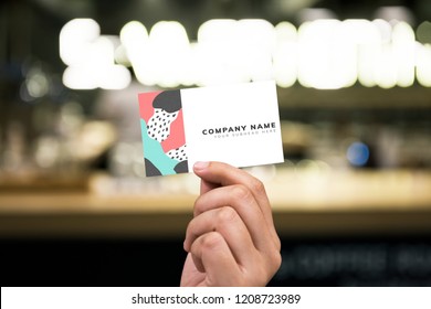 Holding up a business card mockup