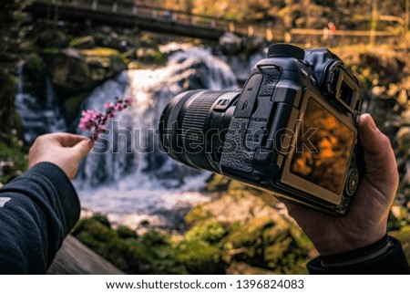 holding a camera in hand