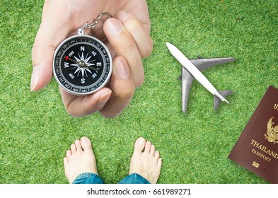 Holding Compass For Nature Travel Direction With Bare Feet