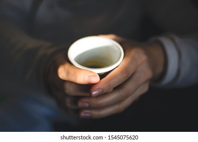 holding a cup of coffee
