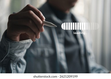 ็Hand holding a digital pen with a virtual loading bar on screen, representing technology, digital progress, user interface interaction, and modern innovation in a digital workspace