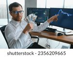 Holding Dollar bills in the stock market. Investors counting money after making it big on the stock market. becoming rich and wealthy. online stock market information