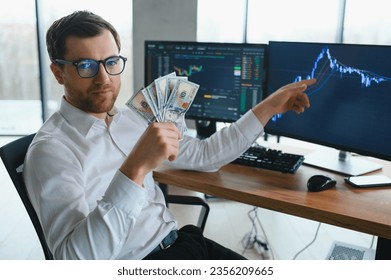 Holding Dollar bills in the stock market. Investors counting money after making it big on the stock market. becoming rich and wealthy. online stock market information