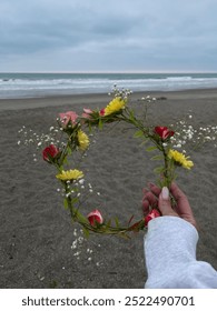 holding a flower crown in the beach