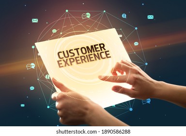 Holding futuristic tablet with CUSTOMER EXPERIENCE inscription, social media concept - Shutterstock ID 1890586288