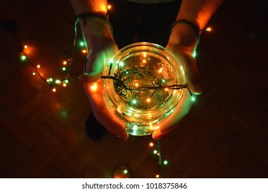 Holding a glass with a light string in it