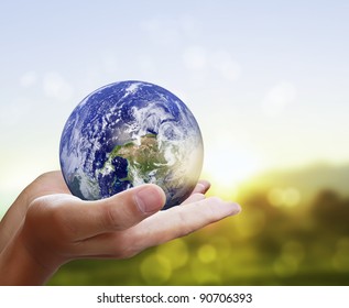 holding a glowing earth globe in his han