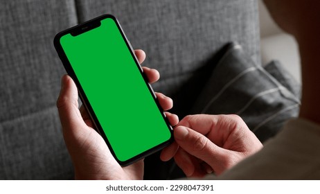Holding a Green Screen Smartphone, Home Background - Powered by Shutterstock