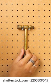 Holding Hand Tools On A Workshop Peg Board.