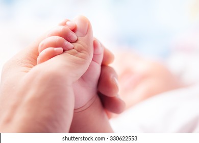 Holding Hands. hand the sleeping baby in the hand of parent close-up - Shutterstock ID 330622553