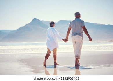 Holding hands, love and an old couple walking on the beach in summer with blue sky mockup from behind. Care, romance or mock up with a senior man and woman taking a walk on the sand by the ocean - Powered by Shutterstock