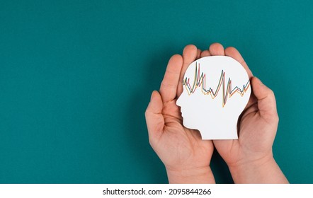 Holding a head in the hands, mental health concept, alzheimer and epilepsy disorder, brain waves