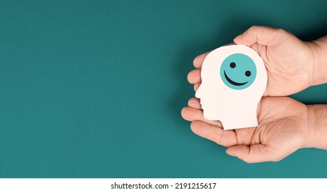 Holding A Head With A Smiling Face In The Hands, Mental Health Concept, Positive Mindset, Support And Evaluation Symbol