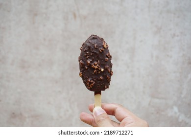 Holding Ice cream chocolate isolated abstract background 