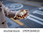 Holding ice-cream waffle - Stock Photo