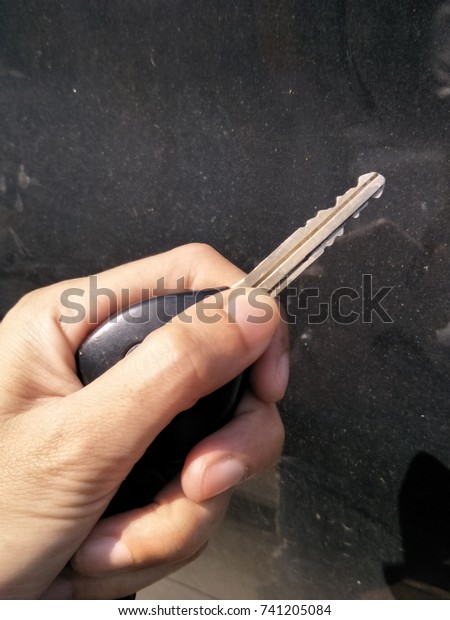 holding a key of the car\
