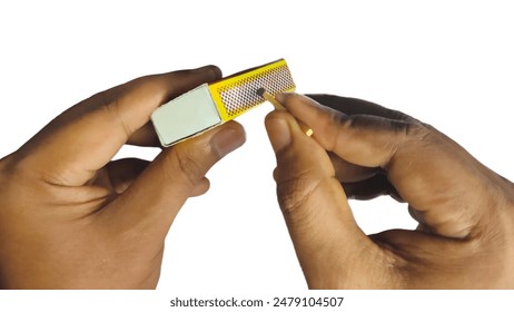 Holding match box fire lighter isolated with two hand and fingers image. Closeup Household cheap wooden matchstick object about to ignite flame at fireplace concept white background png, jpg picture - Powered by Shutterstock