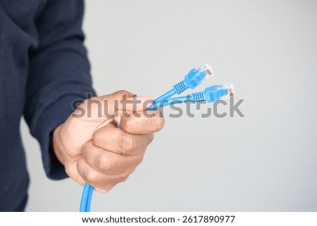 Holding multiple blue network cables for connection setup