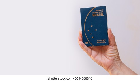 Holding New Mercosur Brazil Passport Isolated On White Background.