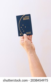 Holding New Mercosur Brazil Passport Isolated On White Background.