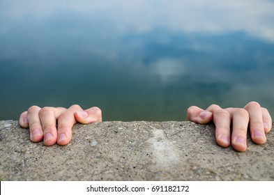 Holding On The Edge Of A Cliff