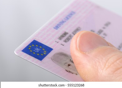Holding out a driving license  - Shutterstock ID 555123268