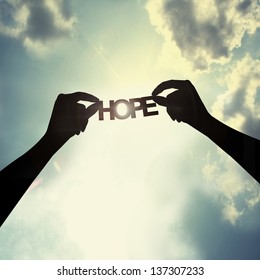 holding a paper cut of hope - Shutterstock ID 137307233