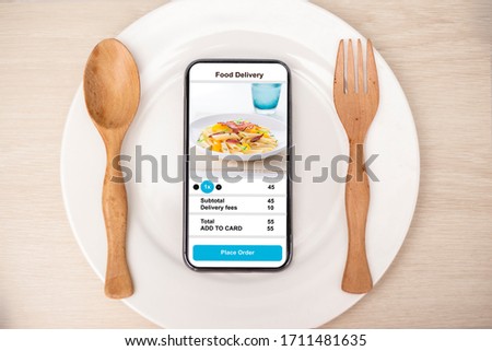 holding phone with application delivery food online