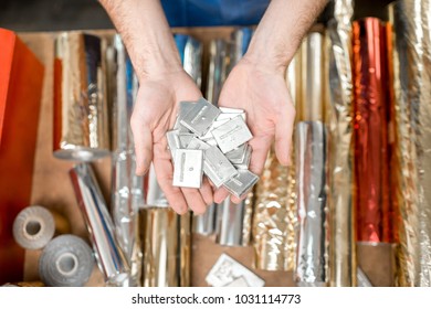 Holding a pile of small metal cliche for stamping with foil at the printing manufacturing - Shutterstock ID 1031114773