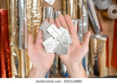 Holding a pile of small metal cliche for stamping with foil at the printing manufacturing - Shutterstock ID 1031114800
