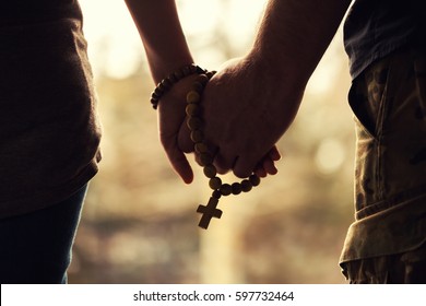 Holding Rosary In Hand.