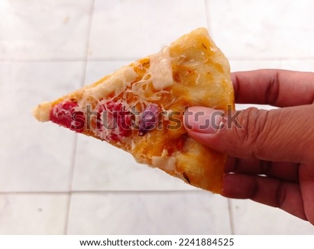 Holding a slice of pizza