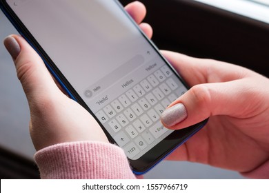 holding a smartphone close-up, writing a message - Shutterstock ID 1557966719