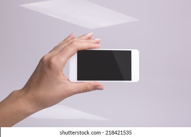 Holding smartphone in hand