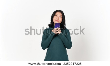 Holding Smartphone Looking up and Thinking Gesture Of Beautiful Asian Woman Isolated On White Background