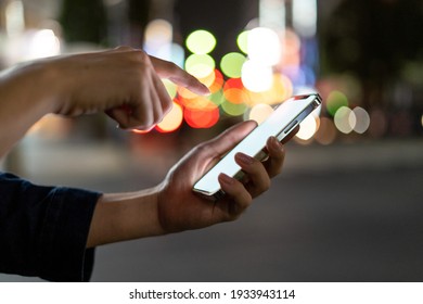 holding smartphone on the street