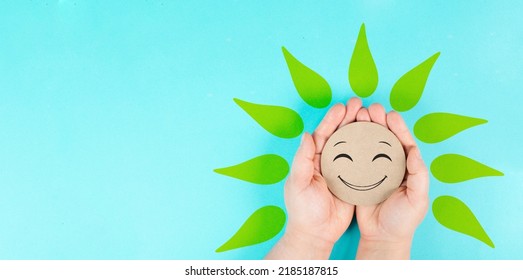 Holding A Smiling Face With Green Petals In The Hands, Mental Health Concept, Positive Mindset, Support And Evaluation Symbol 