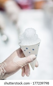 Holding A Snow Cone In A Paper Cup With Gloves