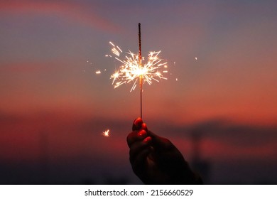 Holding a sparkler for independence day