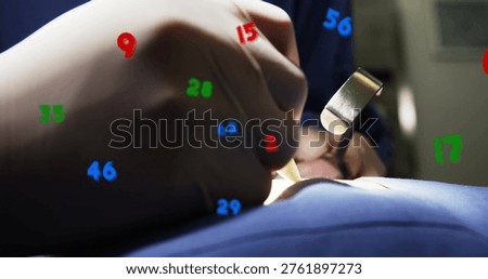 Holding surgeon's gloved hand using scalpel over blue drape in OR, with clamp and numeric overlays. Operatingroom, sterile, teamwork, instrument, retractor, precision, focus